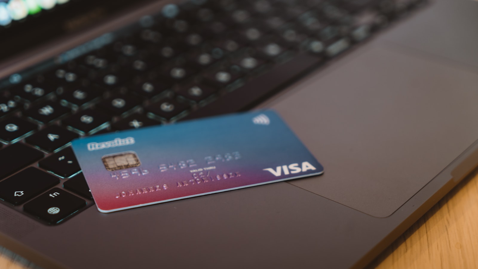 A payment card resting on a laptop keyboard