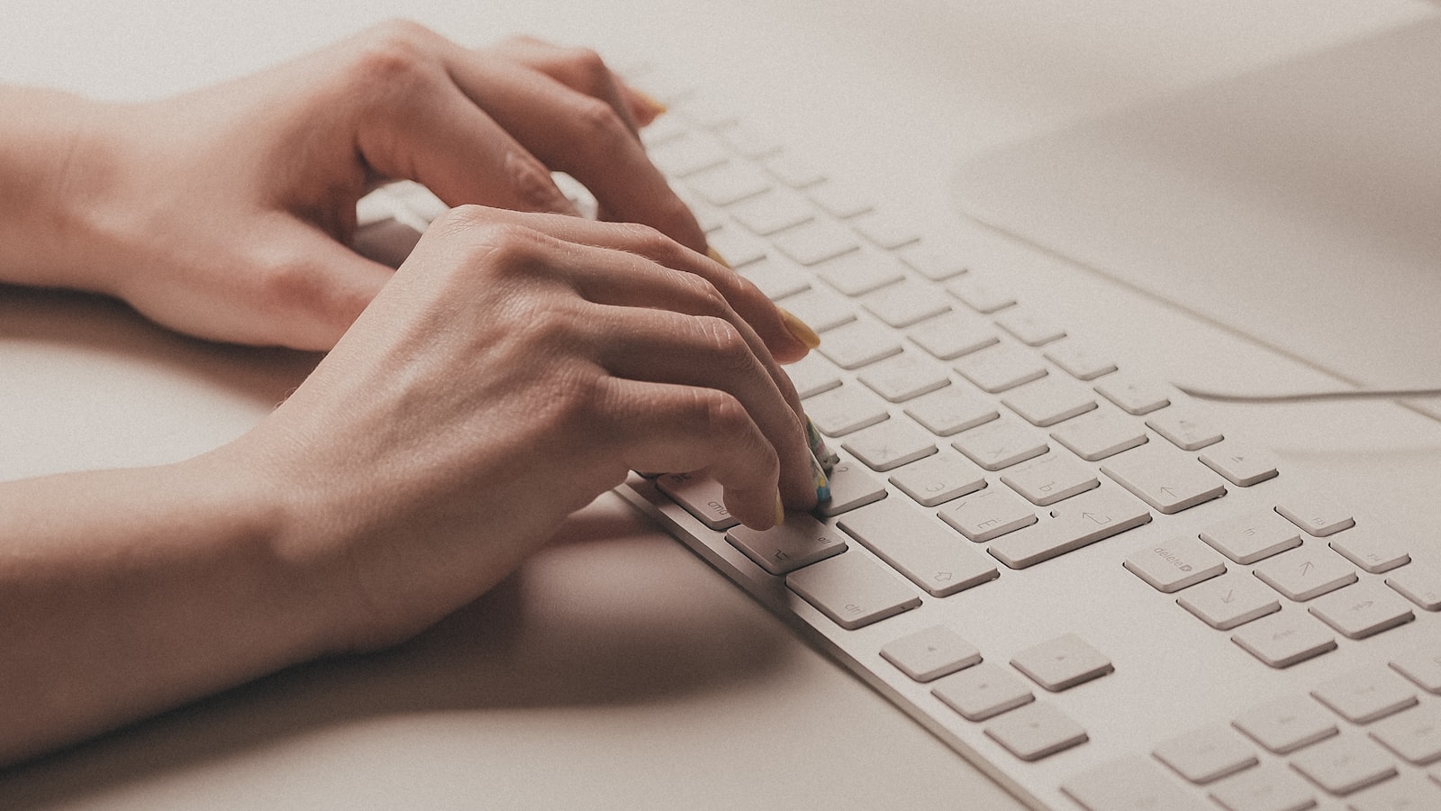A person typing on a computer keyboard